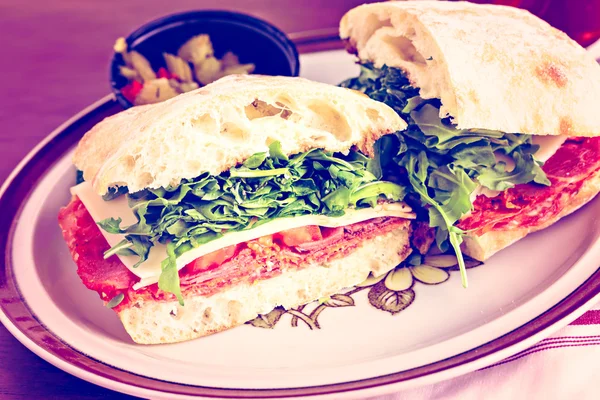 Italian sub sandwich with arugula — Stock Photo, Image