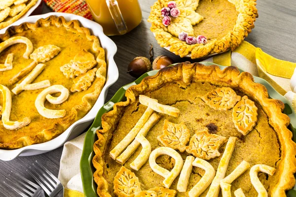 Pumpkin pies with Autumn stamped leaves — Stock Photo, Image