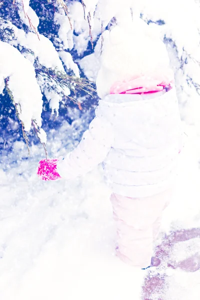 Baby girl playing with snow — Stock Photo, Image