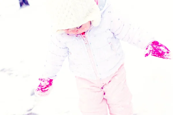 Baby girl playing with snow — Stock Photo, Image