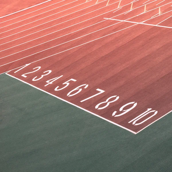 Running race track number screen on ground surface — Stock Photo, Image