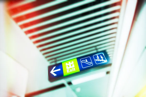 Illuminated Exit Sign in modern public space — Stock Photo, Image