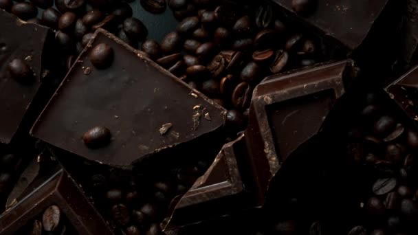 Dark organic chocolate and coffee beans on concrete background — Stock Video