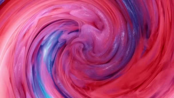 Blended red and blue ink in the background of water on a white background, while creating beautiful swirl shapes. — Stock Video