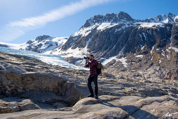 Mies turisti seisoo suuri vuori Skandinavian luonto — kuvapankkivalokuva