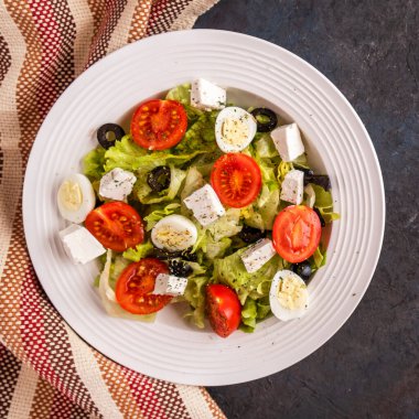 Diyet konsepti: marul, domates, bıldırcın yumurtası, zeytin ve peynirli sebze salatası.