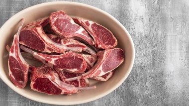 Fotokopi alanı olan bir tabakta çiğ kuzu eti. Üst görünüm.