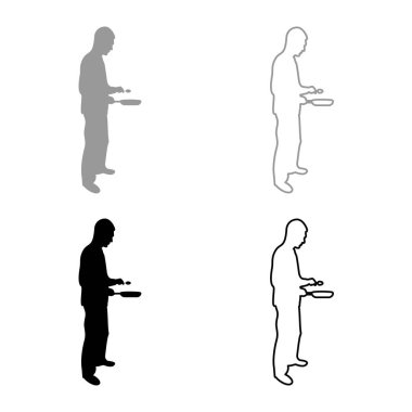 Adam tava kaşığı tutuyor. Mutfak aletleri uzmanı. Mutfak personeli konseptini kullanıyor. Gıda siluetini hazırlıyor.