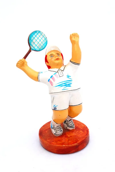 Una pequeña estatua de barro colorido de un jugador de tenis masculino Imágenes de stock libres de derechos