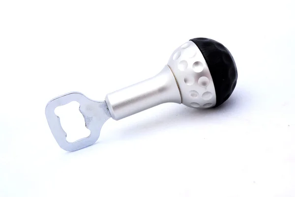A silver metal bottle opener with golf ball — Stock Photo, Image
