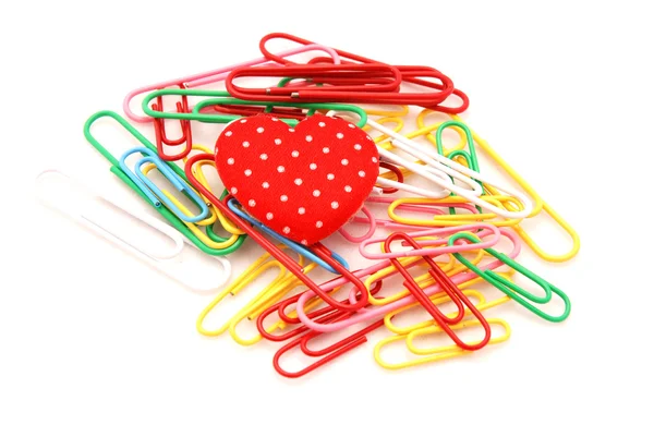 A red heart on top of colorful paper clips — Stock Photo, Image