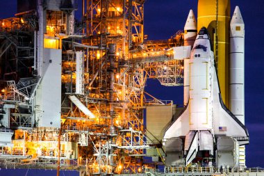 Florida 'daki NASA & # 39; Kennedy Uzay Merkezi' nde STS-133 kargo kutusu, NASA tarafından desteklenen bu görüntünün elemanları olan Fırlatma Pad 39A.background şablonu üzerindeki dönen servis yapısına kaldırıldı.