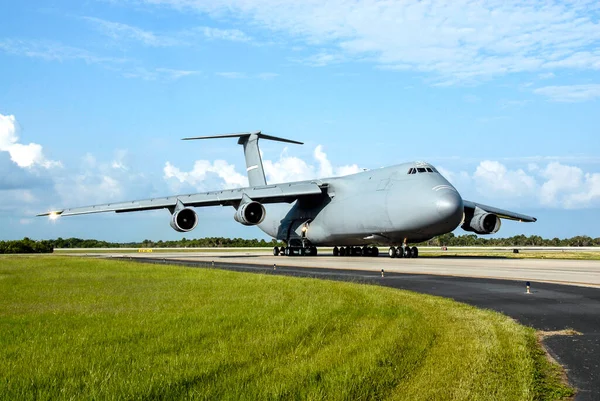 The U.S. Air Force C-17 aircraft arrives at NASA Kennedy Space Center's Shuttle Landing Facility with its SV-1 cargo of the STSS Demonstrator spacecraft. background template , elements of this image furnished by nasa