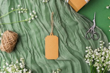 Çiçekli kraft etiketi ve hediye paketi aksesuarlarının üst görünümü