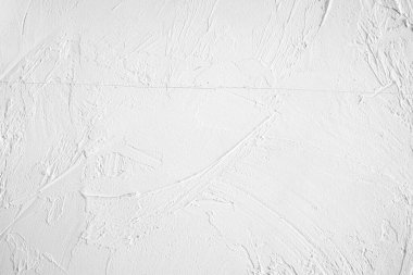 Çeşitli soyut desenlere sahip desenli beyaz duvarın yakın görüntüsü.