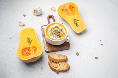 Taze biberiye sarımsaklı kabak çorbası ve tahtada kızarmış ekmek, sağlıklı sonbahar yemeği.