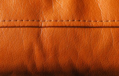Döşeme arka planı ve mobilya tasarımı için görünür dikişli turuncu deri dokusu