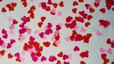 Sevgililer Günü için dağılmış parlak kırmızı ve pembe kalp şekilleri aşk ve tutku duygularını ifade eder.