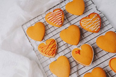 Enfes pişmiş kalp şeklinde şekerlemeler, güzelce süslenmiş kremayla, sıcaklığı ve tatili sevmeyi iletin..