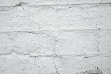White brick wall texture background with rough surface and small cracks for design