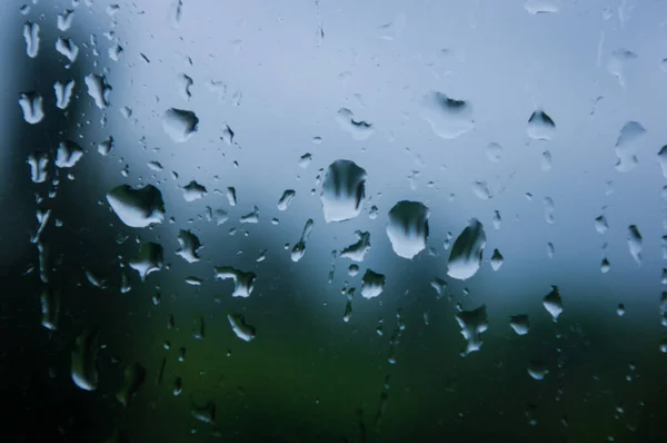 Natural summer background - raindrops on the window glass, close up