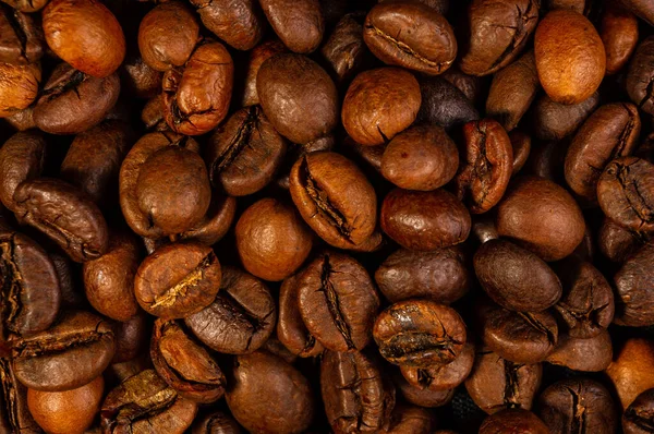 Natural background for Cafe menu or brochure template - macro photo of brown roasted coffee beans, close-up.