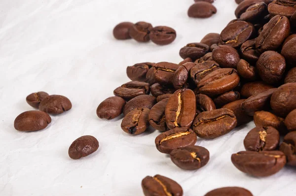 Natural background for Cafe menu or brochure template - macro photo of brown roasted coffee beans, close-up.