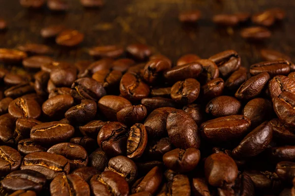 Natural background for Cafe menu or brochure template - macro photo of brown roasted coffee beans, close-up.