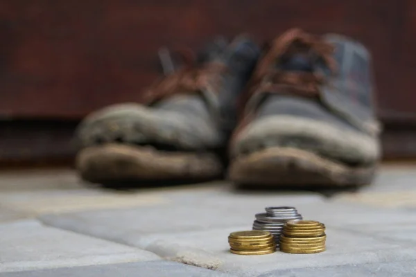 Stacked Coins Blurred Background Pair Dirty Old Boots Concept Poverty — Stock Photo, Image