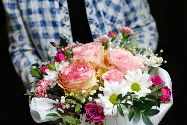 Man gives flowers. Gift box with flowers. Close up of box with pink roses in male hands. Male give gift for mothers day, valentines, women day, birthday. Selective focus