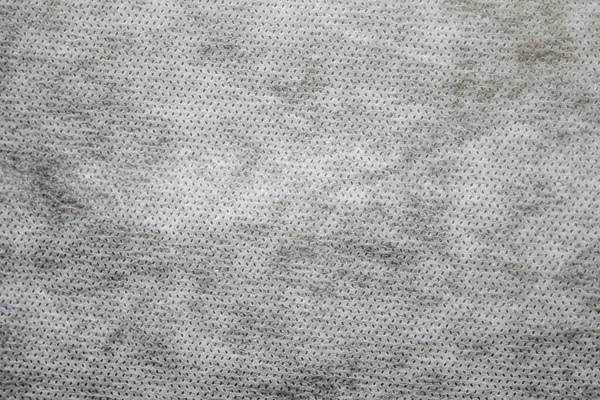 Defocus grey spunbond non-woven geotextile close-up macro. Close up. Small spots. Dirtied texture. Design, background, backdrop. Out of focus.