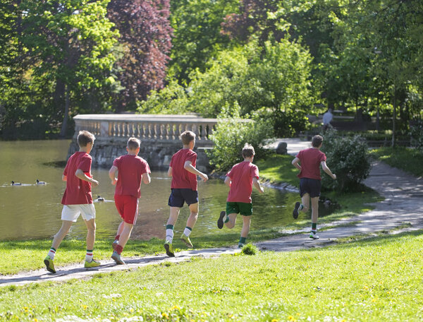 Young boys run in park