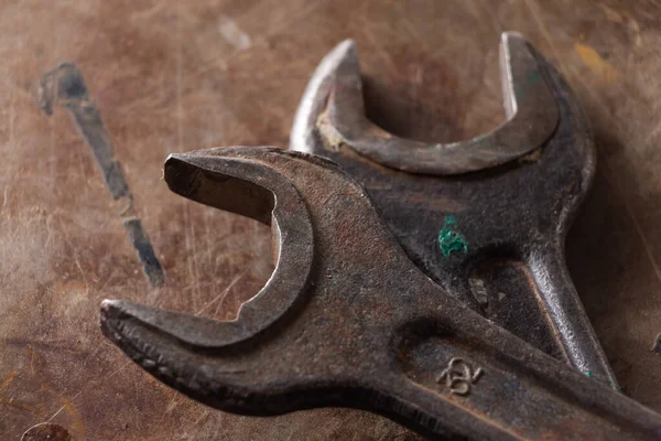 Crossed old wrenches on the workshop table