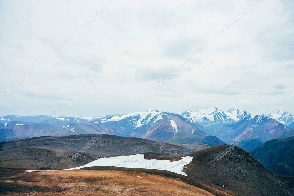 Atmospheric alpine landscape to rocky mountain with glacier. Snowy rockies in highland valley and giant glacial ridge. Snowy mountain range. Flying over mountains. Wonderful scenery on high altitude.
