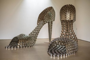 Wakefield, UK - June 10, 2021: Marilyn 2011 by Joana Vasconcelos, elegant pair of high-heeled sandals, whose enlarged scale results from the use of saucepans and their respective lids. clipart