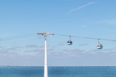 Lizbon 'da arka planda Vasco da Gama köprüsü olan bir teleferik..