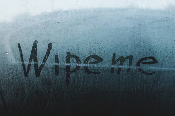 The inscription on the fogged glass on a cool morning, wipe, wipe me