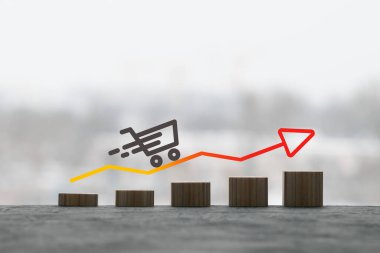 Tahta küpler, bir ok ve bir sepet ürün büyüme grafiklerini temsil ediyor.