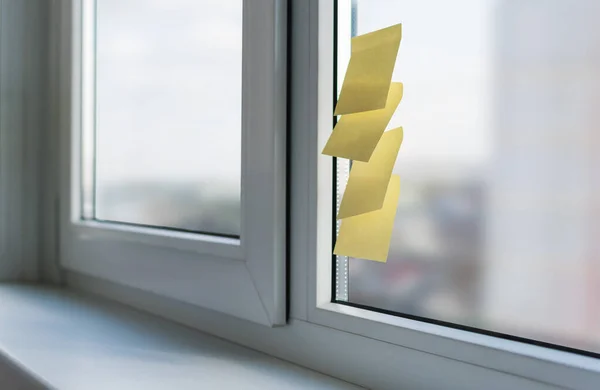 There are several stickers for notes on the glass of the plastic window