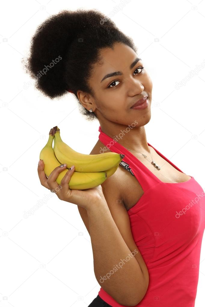 black girl holds bananas in hand