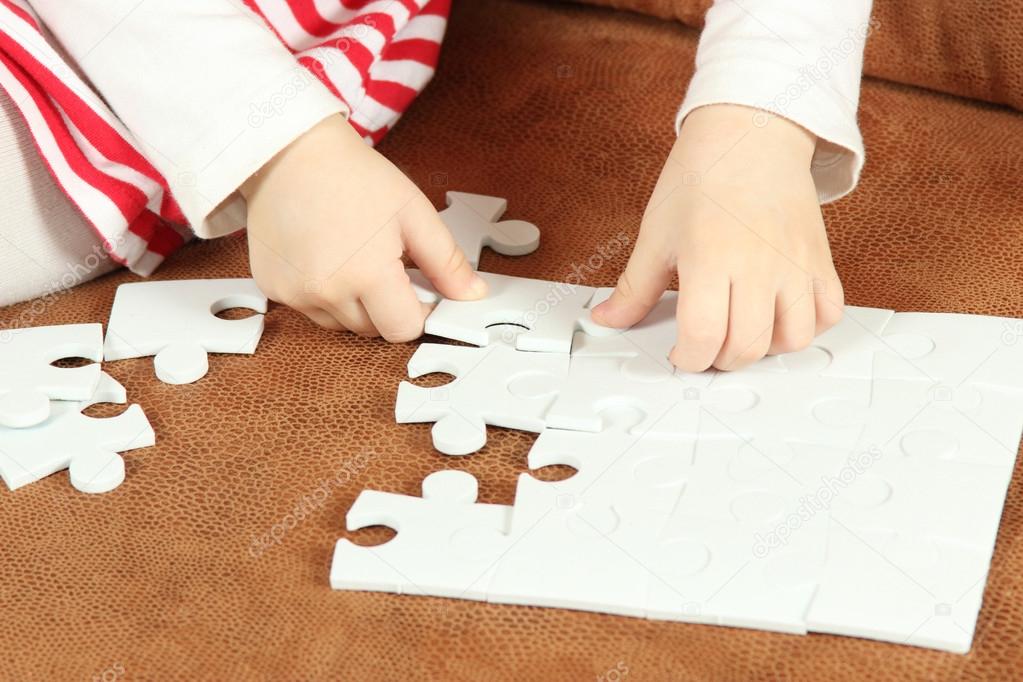 little Girl Playing With Puzzle Pieces