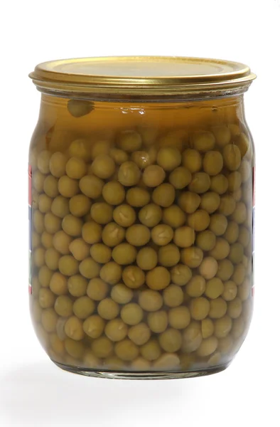 Glass jar of preserved peas Royalty Free Stock Photos