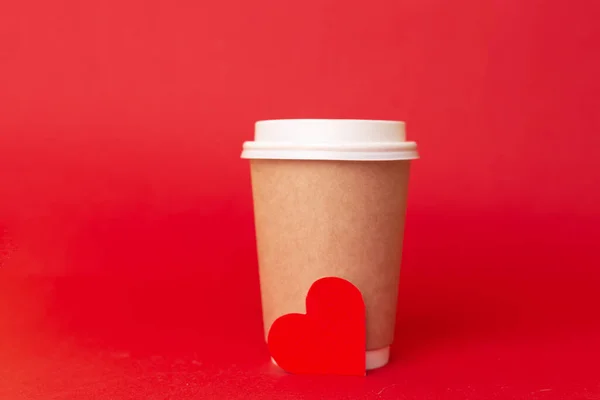 赤の背景に赤のハートの紙コップ バレンタインデーのロマンチックなテイクアウトコーヒーのコンセプト コーヒーと旅行への愛 — ストック写真