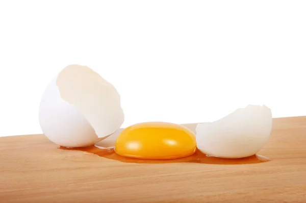 Broken raw egg on a cutting board — Stock Photo, Image