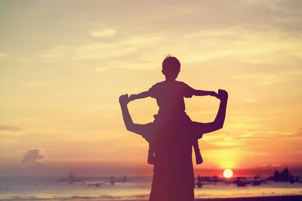 Father and son on sunset beach — Stock Photo, Image