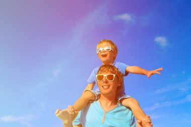 Baba ve küçük oğlu yaz göğün üzerinde oynama