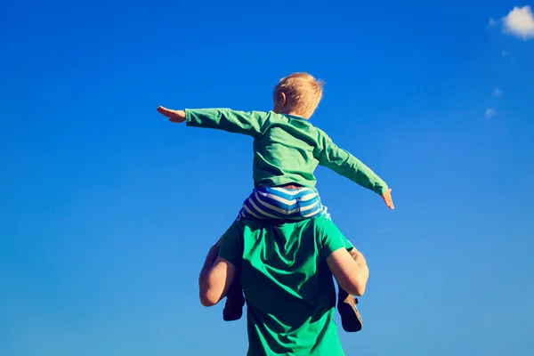 Father and son having fun on sky — Stock Photo, Image