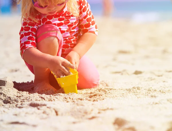 Little girl play with toys on beach — Stock Photo, Image