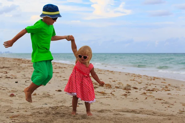 Crianças felizes brincam na praia de verão — Fotografia de Stock