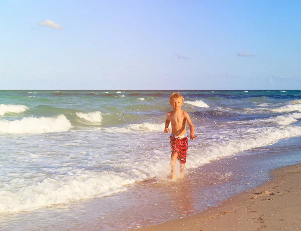 Boy running on sand beach — Stock Photo, Image